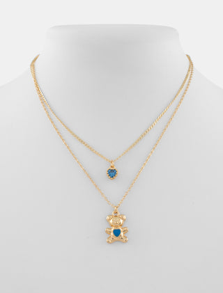 COLLAR DOBLE EN CHAPA DE ORO CON DIJES DE CORAZÓN Y OSITO CON DETALLES EN COLOR AZUL - MICHELLE ACCESORIOS