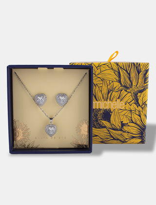 SET EN CHAPA DE ORO COLOR PLATA DE LA COLECCIÓN EL ARTE DE SER MAMÁ DE ARETES TIPO BROQUEL Y COLLAR CON DJE DE CORAZÓNCON PIEDRA DE ZIRCONIA INCLUYE CAJA DE REGALO PARA MAMÁ - MICHELLE ACCESORIOS