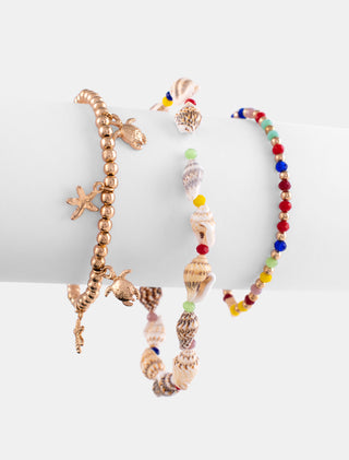 JUEGO DE TRES PULSERAS CON CUENTAS DE COLORES CONCHITAS DE MAS Y DORADA CON DIJES DE ESTRELLAS Y TORTUGAS DE MAR - MICHELLE ACCESORIOS